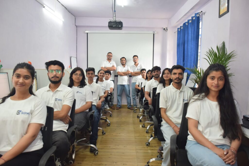 Students in white shirts focused on their computers during a training program at Gashwa Institute of Technical Education Private Limited.