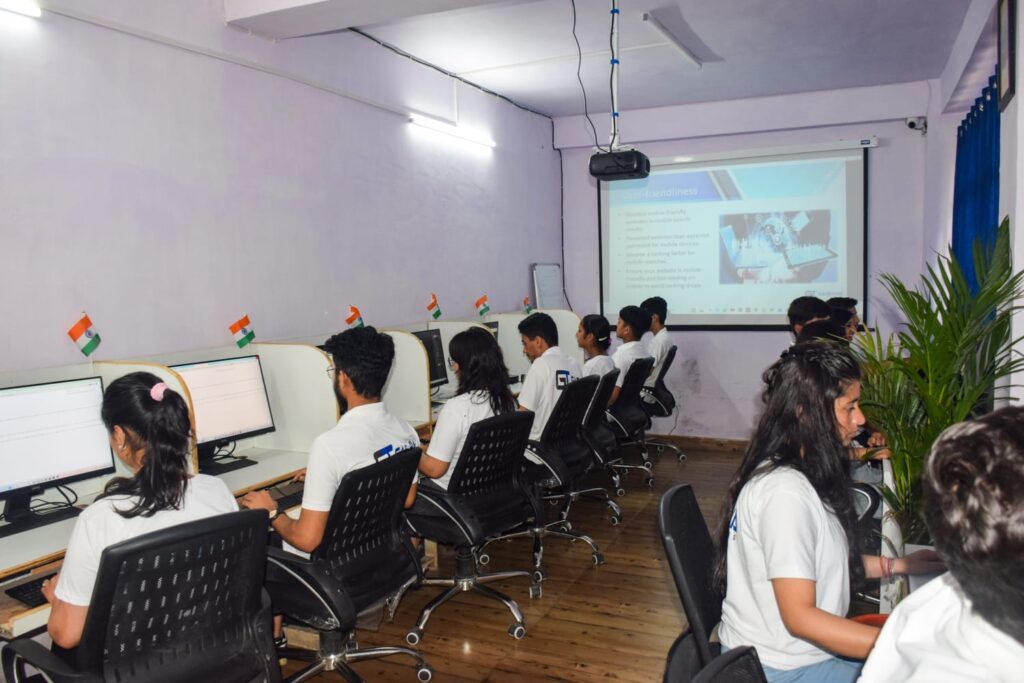 Students in white shirts focused on their computers during a training program at Gashwa Institute of Technical Education Private Limited.