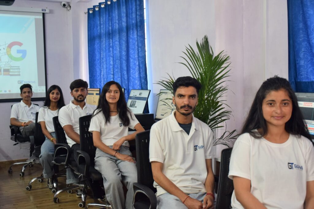 Students in white shirts focused on their computers during a training program at Gashwa Institute of Technical Education Private Limited.