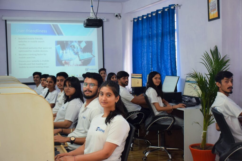 Students in white shirts focused on their computers during a training program at Gashwa Institute of Technical Education Private Limited.