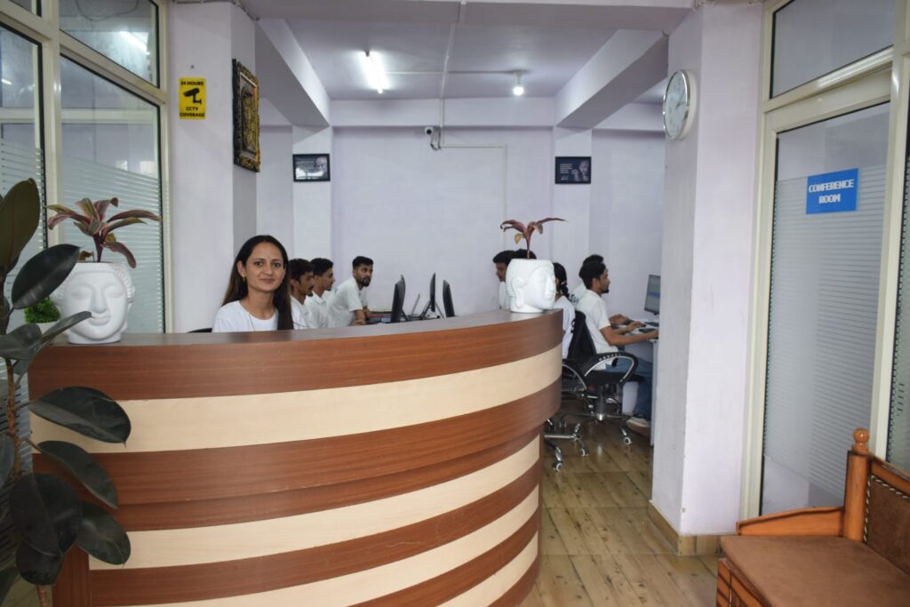 Receptionist at Gashwa Institute of Technical Education, a woman sitting at the desk in a compact office, ready to assist clients.