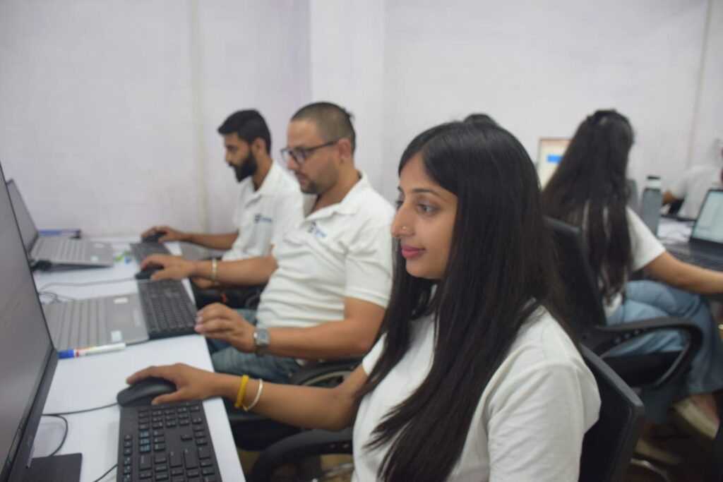 Gashwa Institute of Technical Education employees focused on their computers and teamwork.