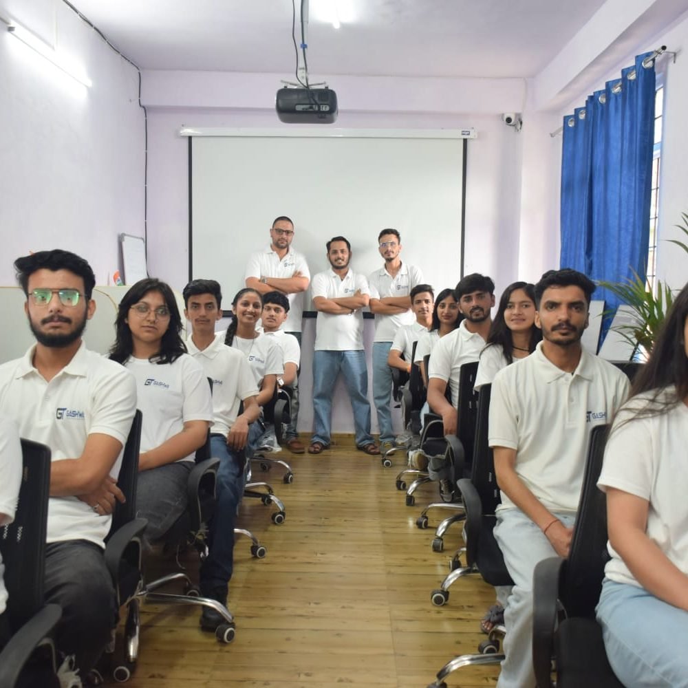 Students in white shirts focused on their computers during a training program at Gashwa Technologies Private Limited.