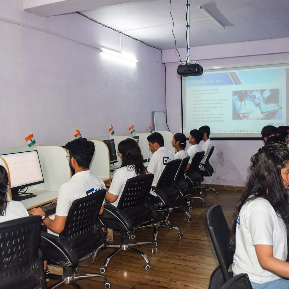 Students in white shirts focused on their computers during a training program at Gashwa Technologies Private Limited.