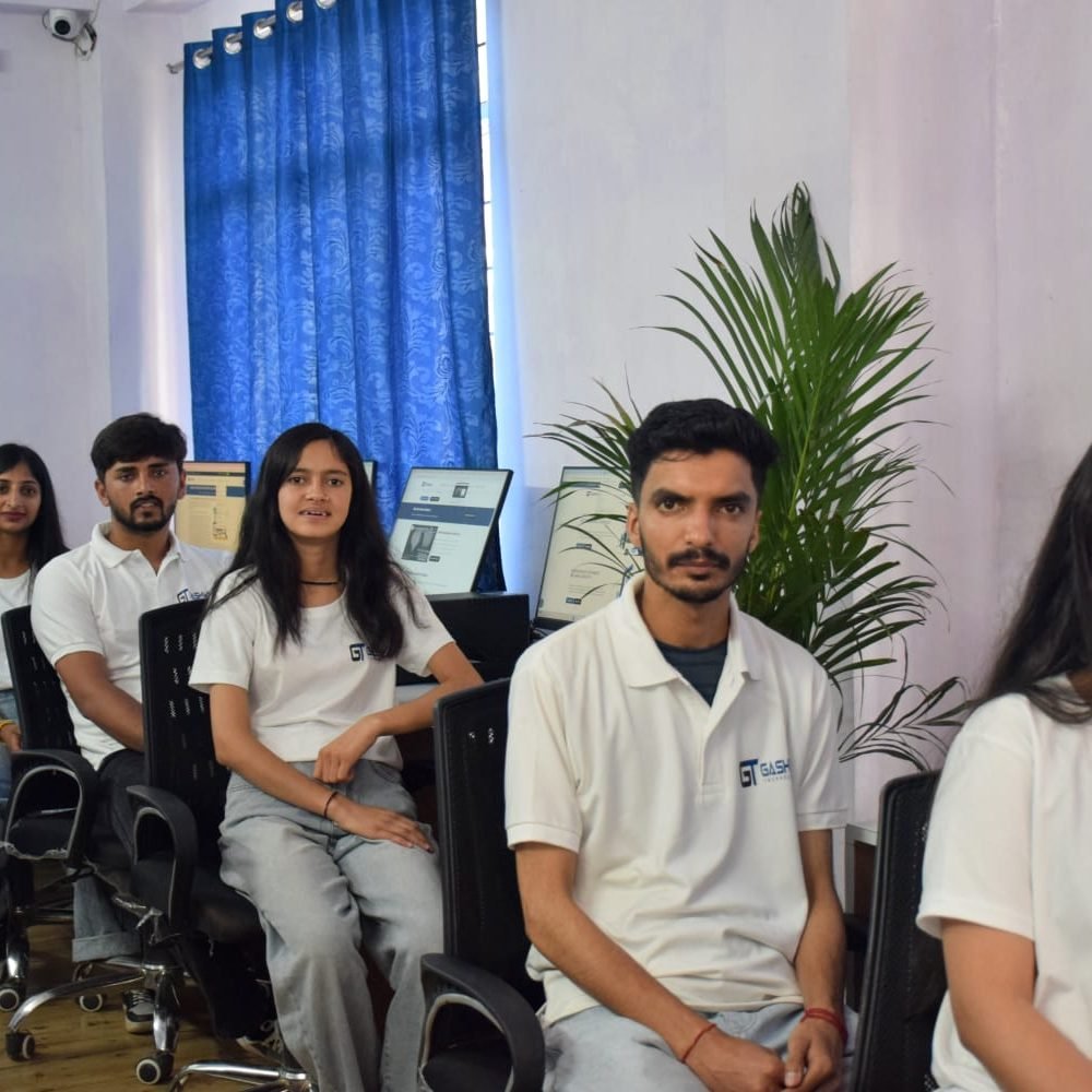 Students in white shirts focused on their computers during a training program at Gashwa Technologies Private Limited.