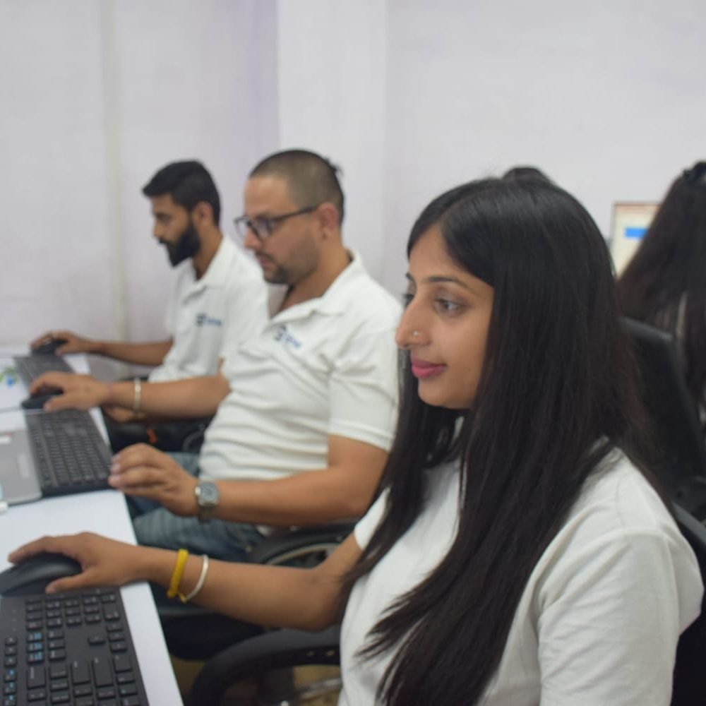 Gashwa Technologies employees focused on their computers and teamwork.