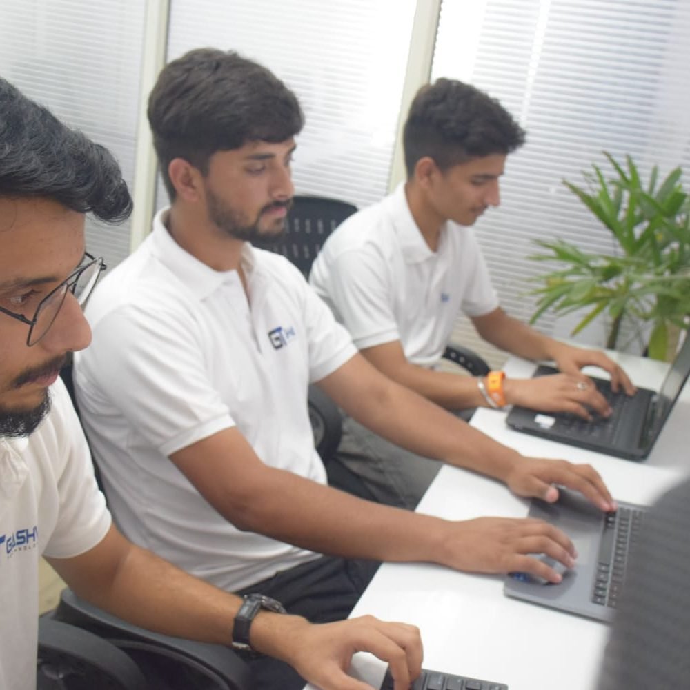 Digital marketing training at Gashwa Technologies featuring three men in white shirts working diligently on their computers.