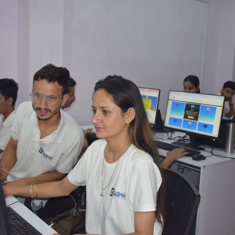 Two employees helping each other on their work at Gashwa Technologies