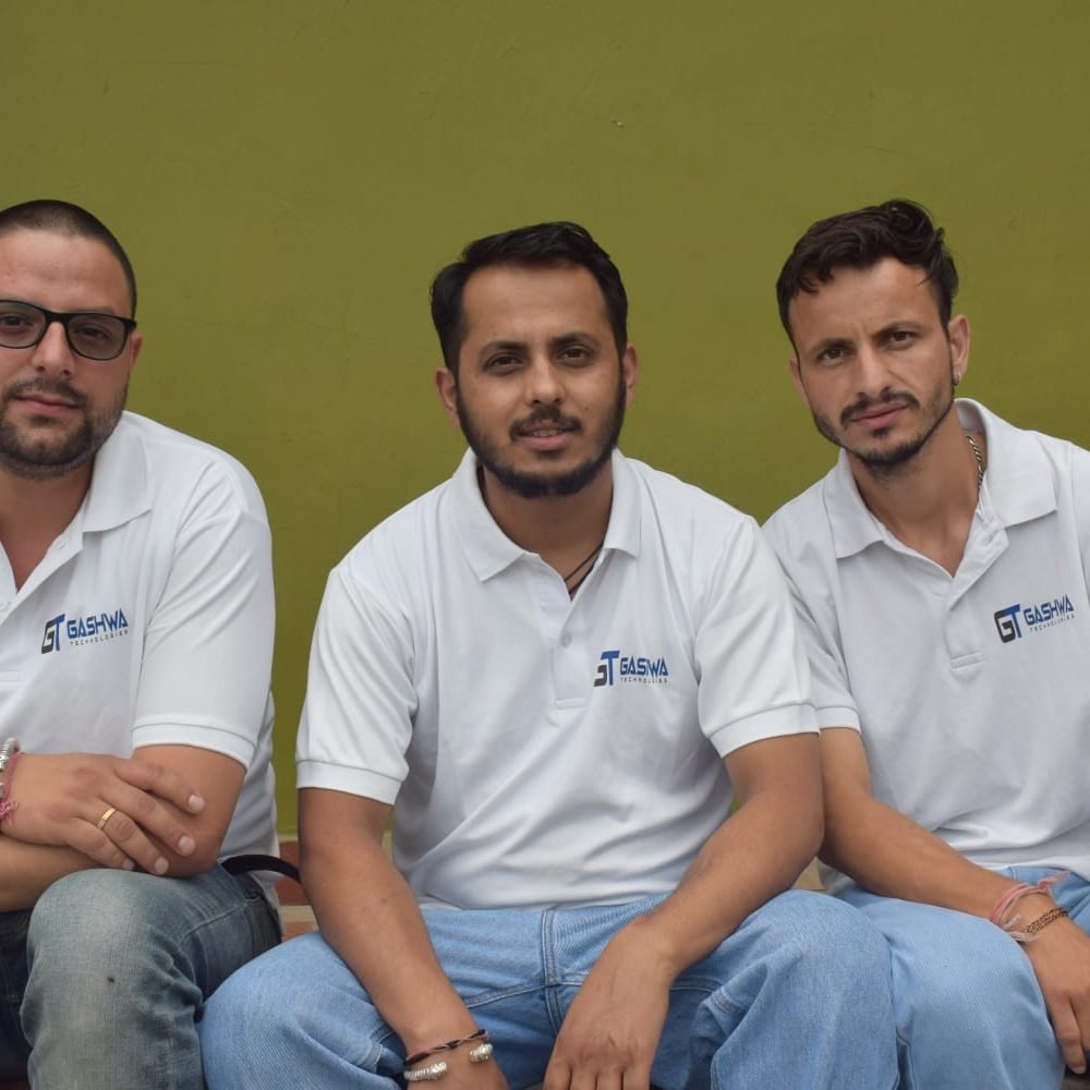 Three people wearing white shirts symbolizing collaboration and success at Gashwa Technologies Private Limited.